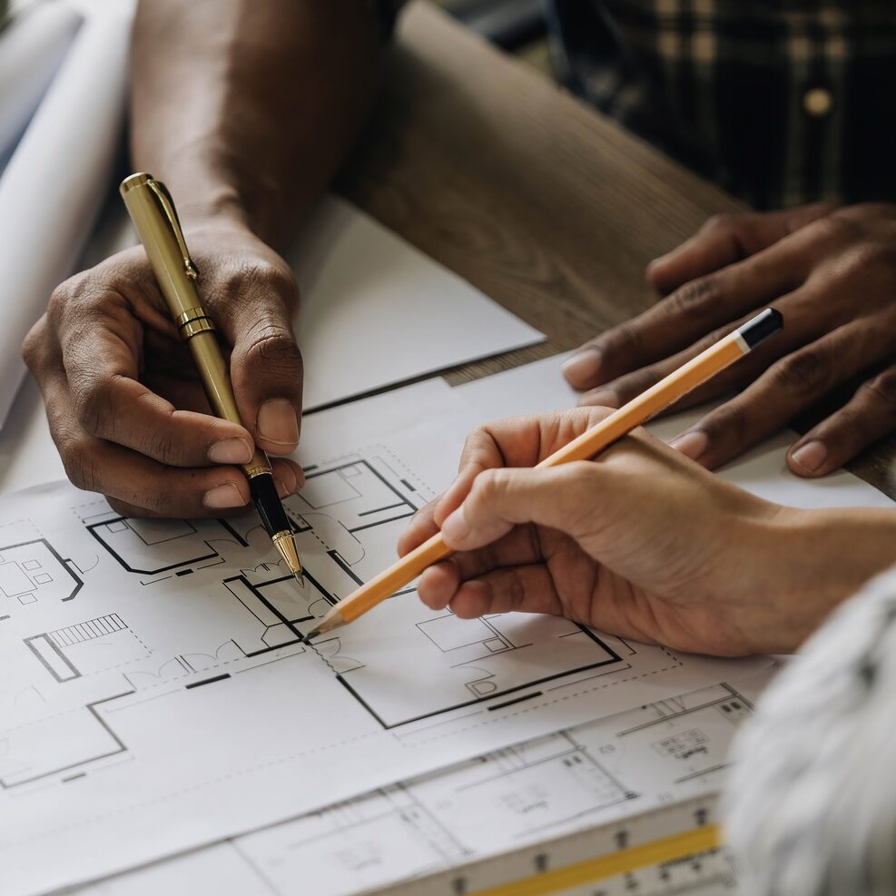 Team construction engineers working at construction site with blueprint on table